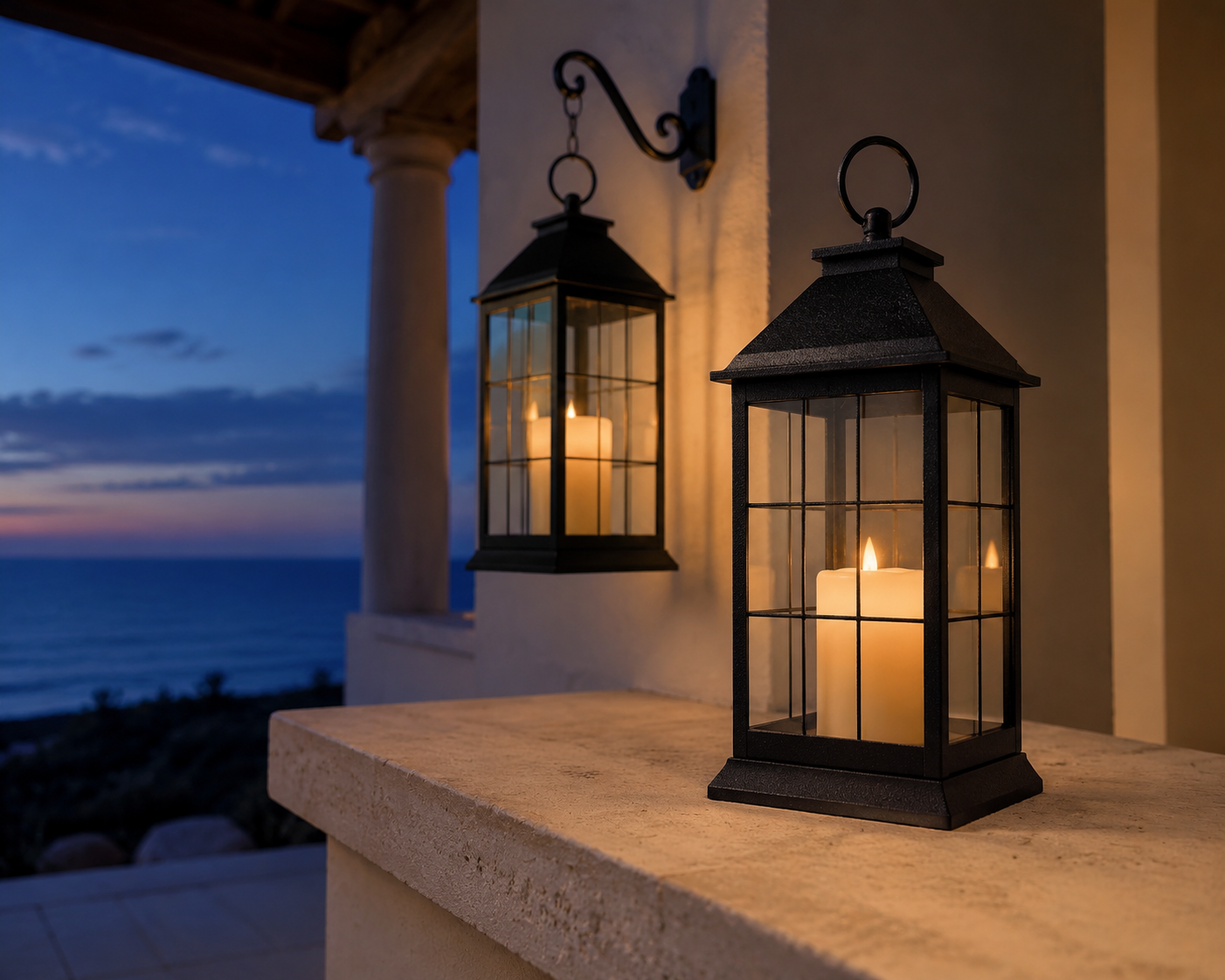 Two matching black Bright Zeal LED candle lanterns on a coastal veranda at dusk